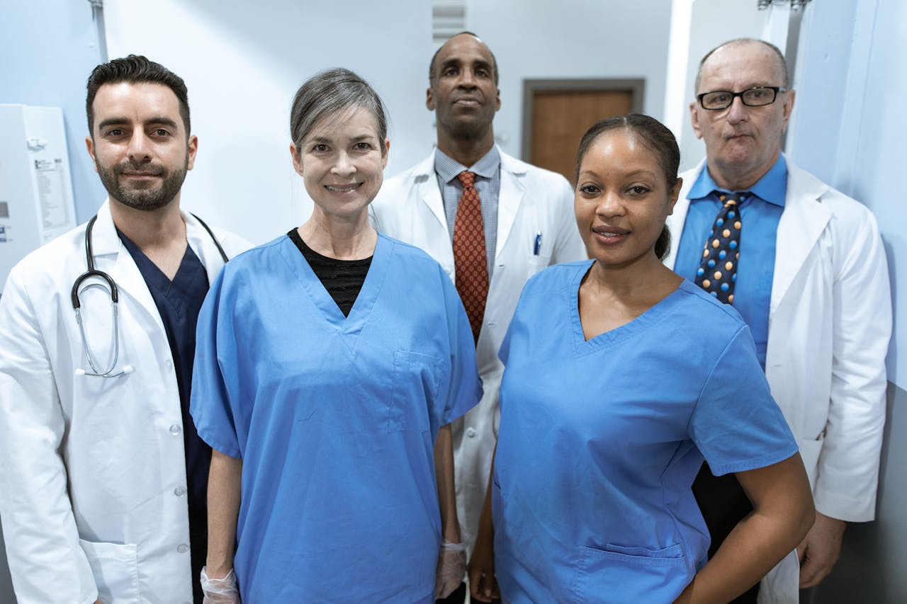 Group of diverse healthcare professionals posing confidently indoors.